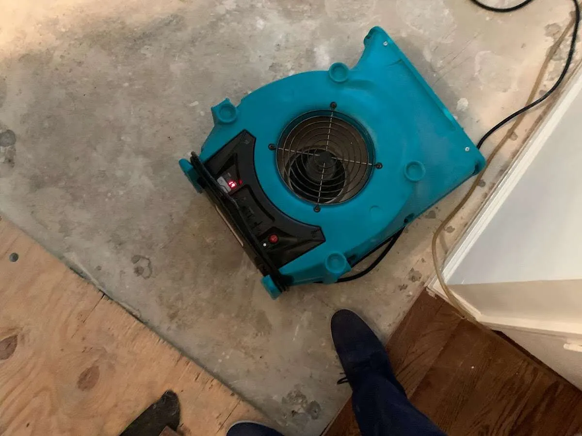 Air mover drying subfloor during Commercial Water Damage Restoration in Norcross